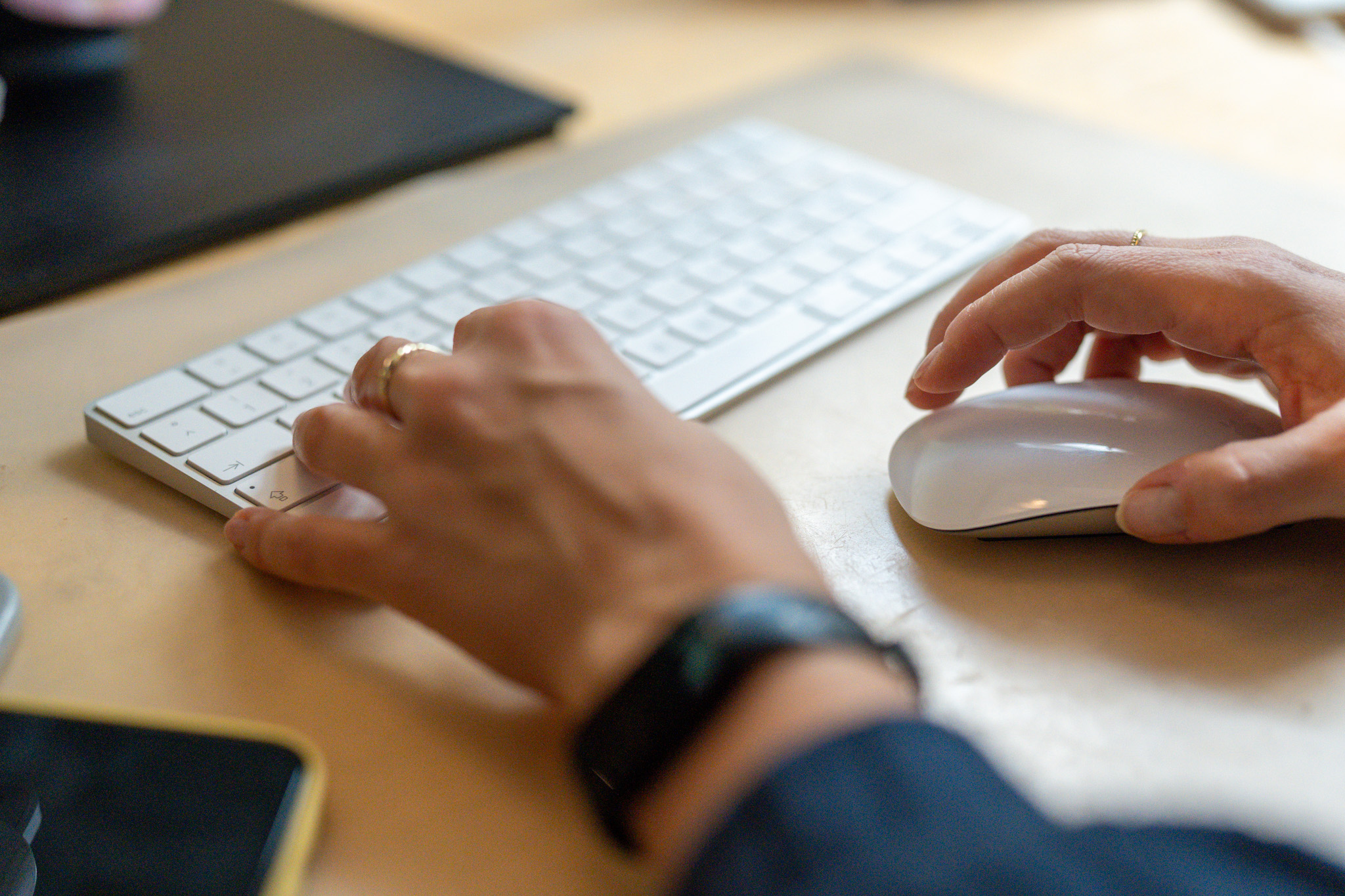Close-up of a person typing on a laptop keyboard